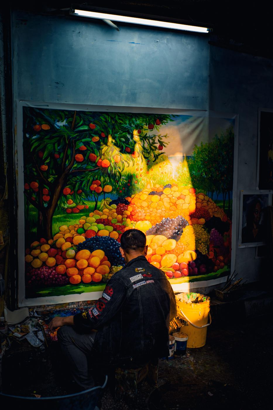 Artist painting a still life in warm studio light