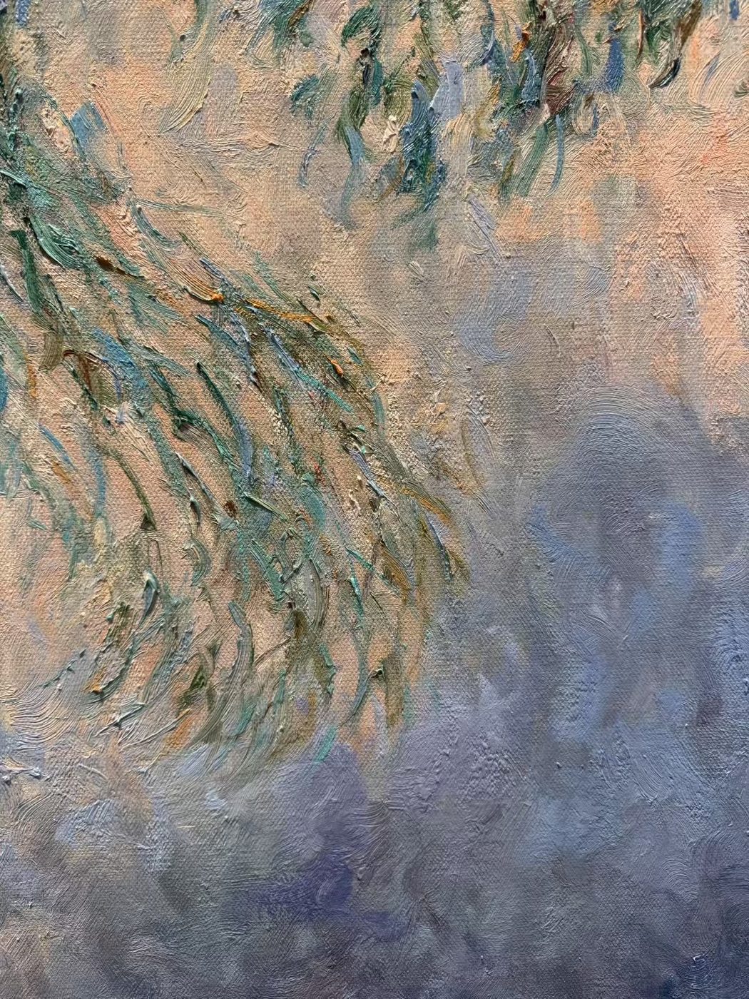 Close-up of brushstrokes on a Monet-style reproduction showing impasto texture