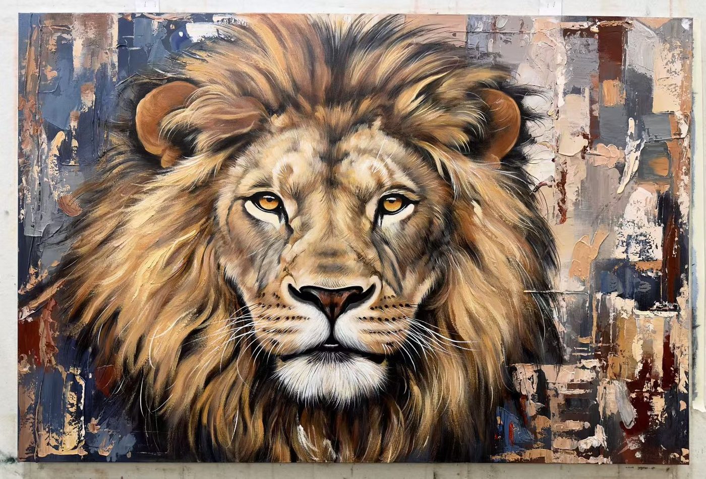 Large hand-painted oil portrait of a lion, displayed in the studio