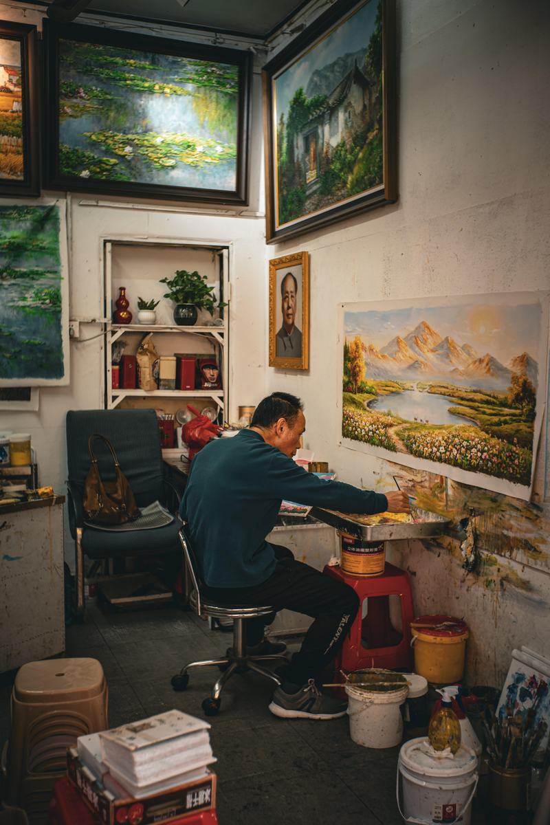 Artist painting landscape in studio