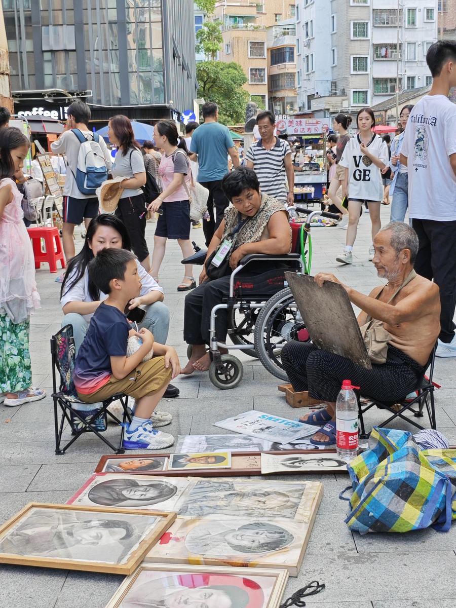 Street painter at an elderly portrait stall