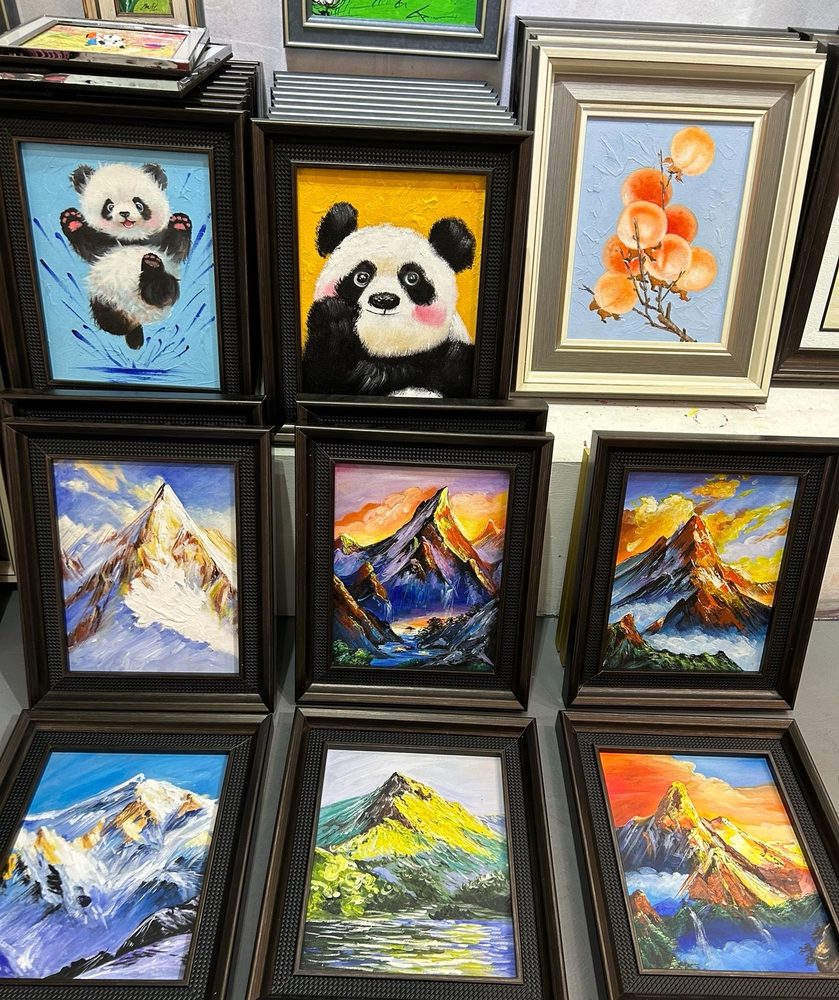 Stacked oil paintings of pandas in a frame