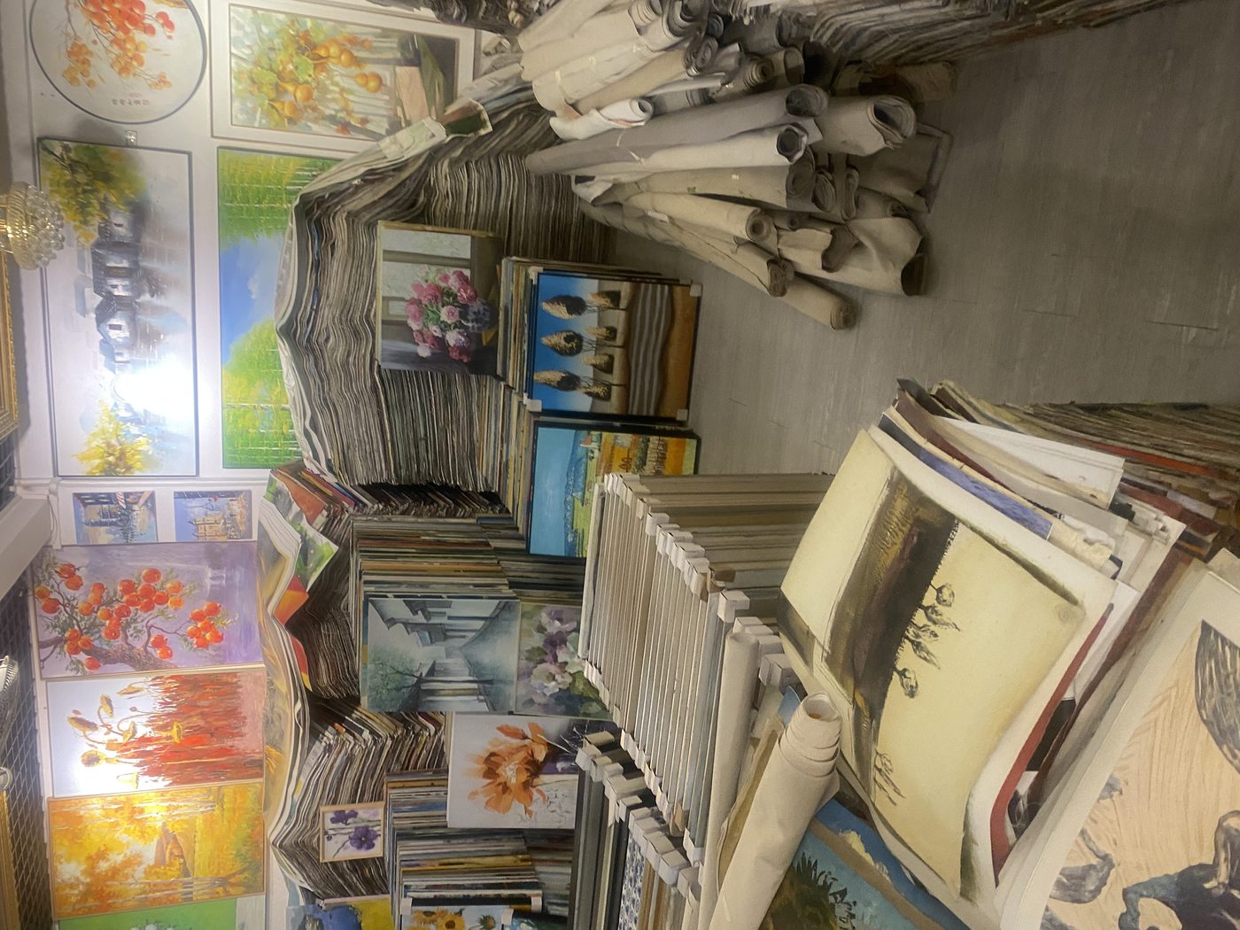 Dafen warehouse floor covered with finished oil paintings in bulk