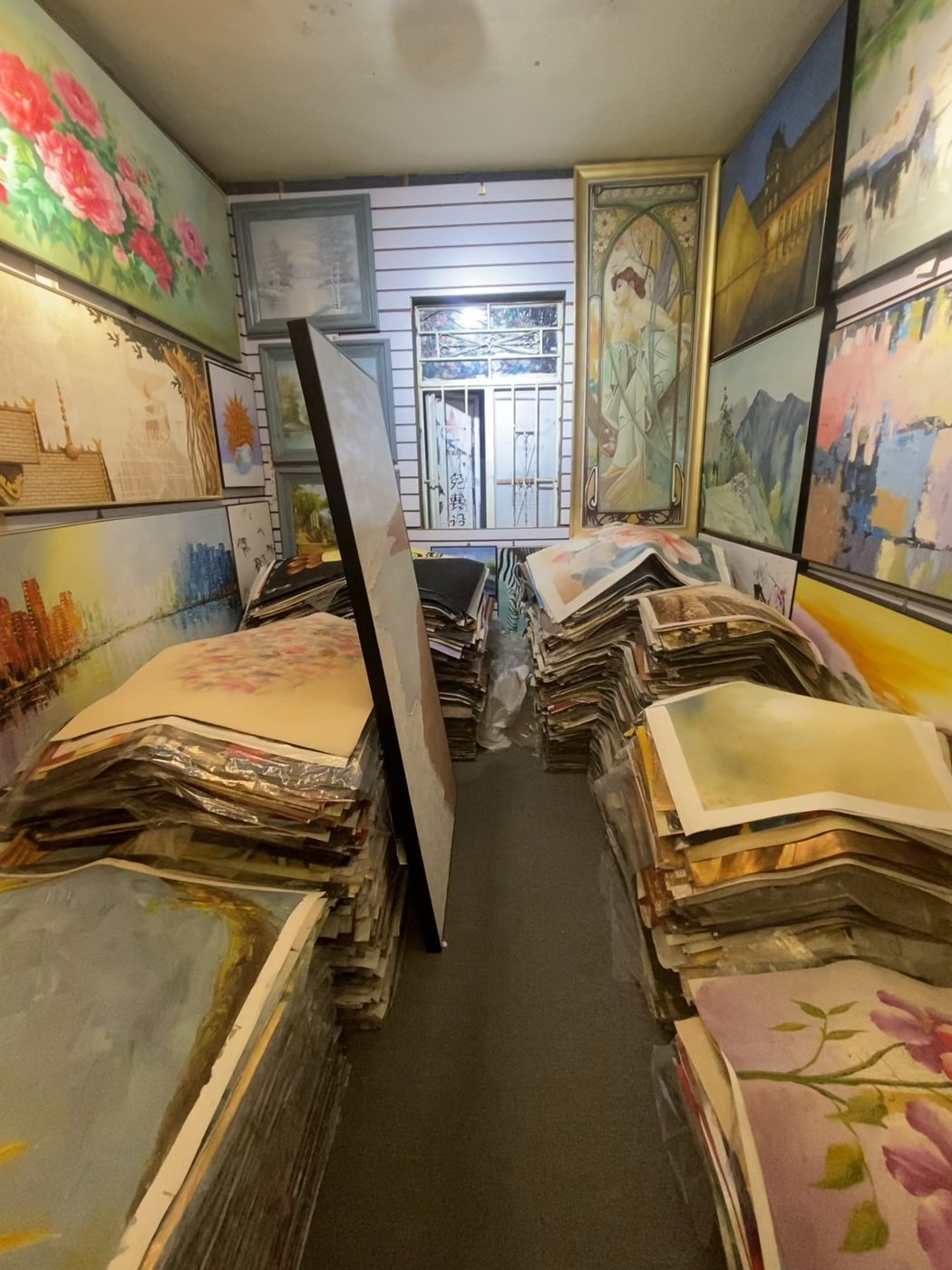 Corridors of hand-painted oil paintings packed for bulk supply in Dafen