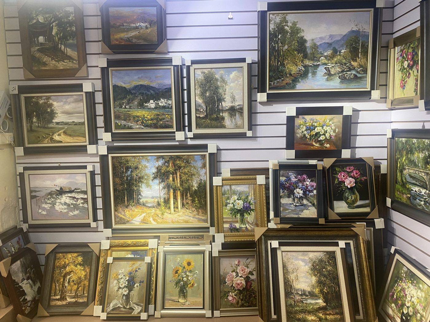 Racks of finished oil paintings in a Dafen warehouse